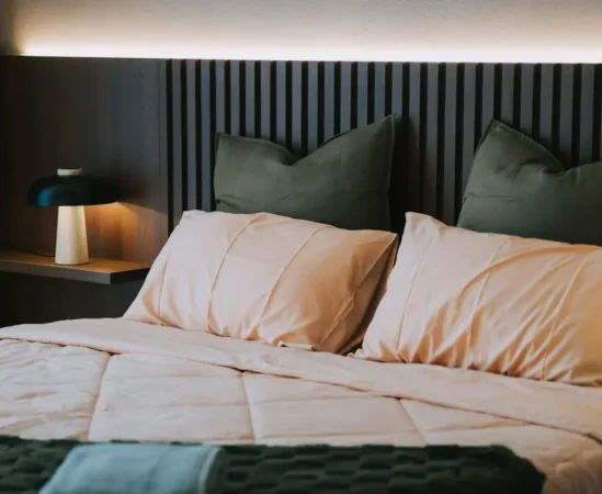 Cozy bed with soft pillows and blanket.
